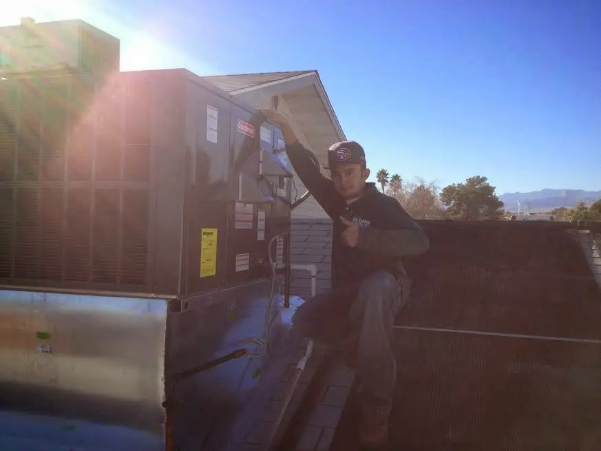HVAC technician performing Boiler Repair on a rooftop unit in Rockville